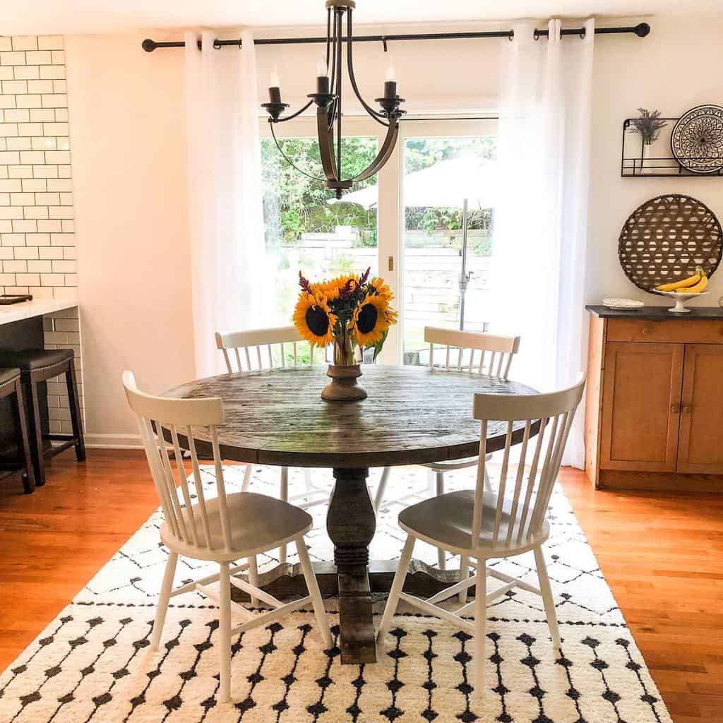 small dining room round dining table four chairs wood flooring chandelier