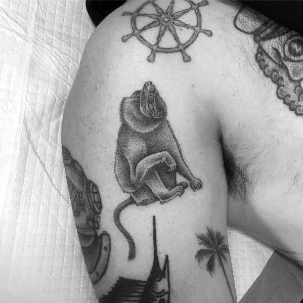 Black and grey baboon tattoo with fine dotwork shading, depicting a seated pose with a fierce expression, creating a detailed and artistic thigh design.