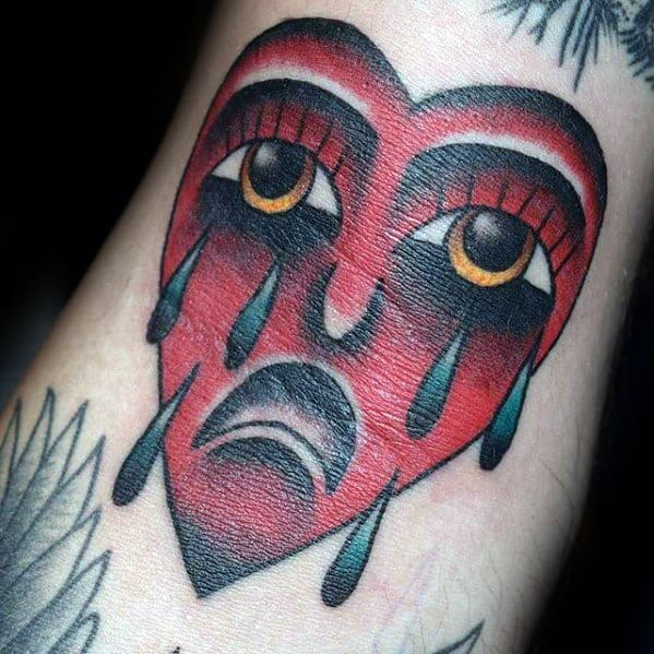 Small Dtich Red Ink Traditional Crying Heart Mens Tattoo Ideas
