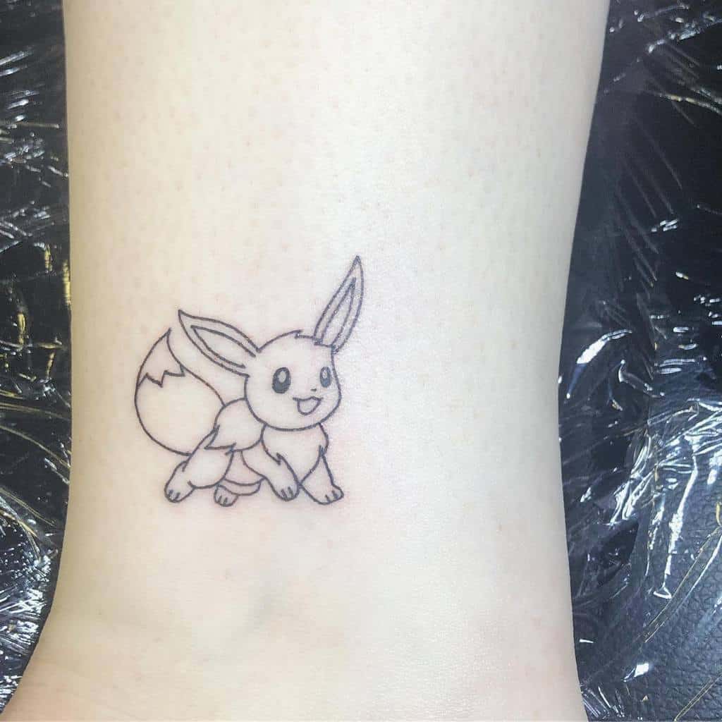 Minimalistic line-art Eevee tattoo showcasing a playful pose with fine detailing on the ears and tail