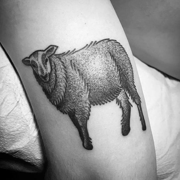 Black and gray tattoo of a textured sheep on an arm