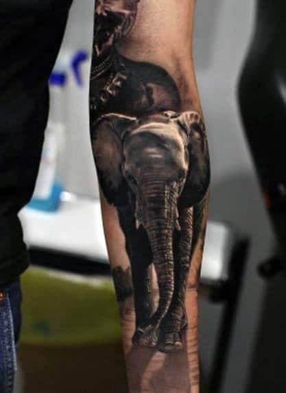 Forearm tattoo of a realistic elephant in black and grey ink