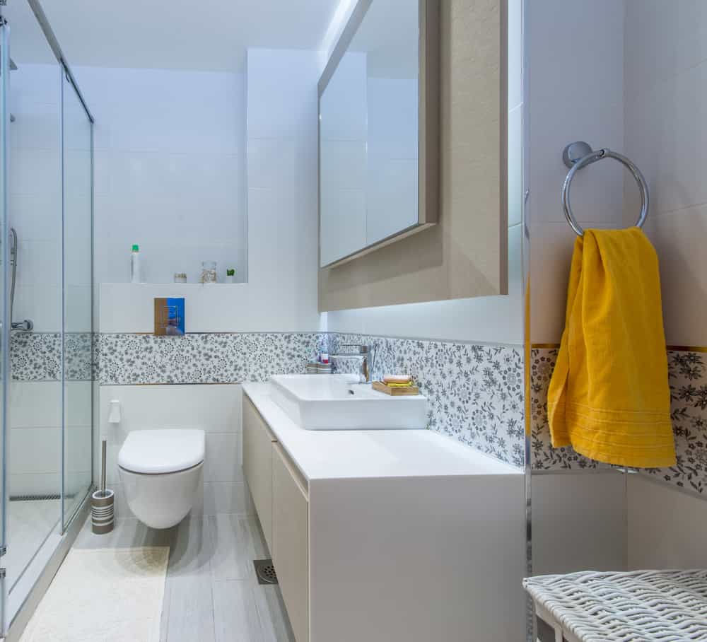 small narrow full bathroom with pattern tiles