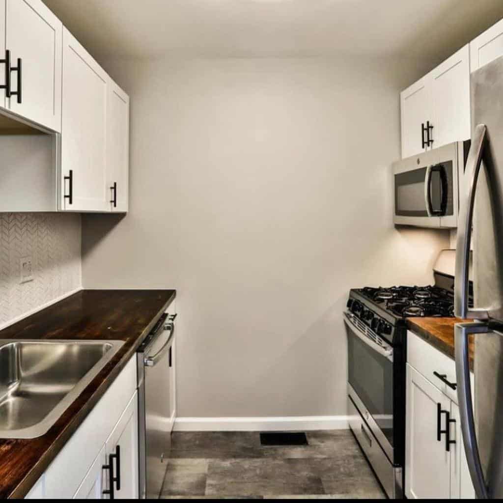 small basic galley kitchen white cabinets black accents
