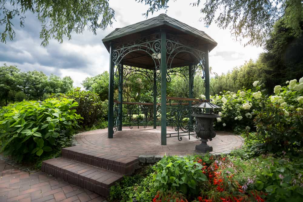 small metal green gazebo paved patio