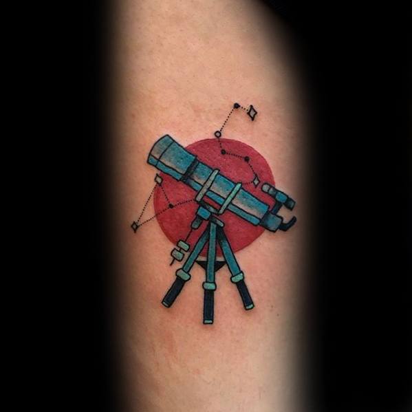 Telescope tattoo features a red circle with constellation details