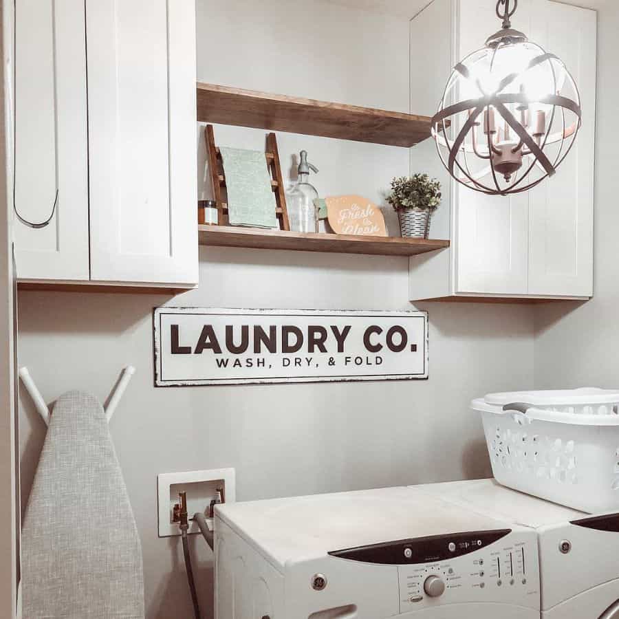 rustic laundry with white wood cabinets