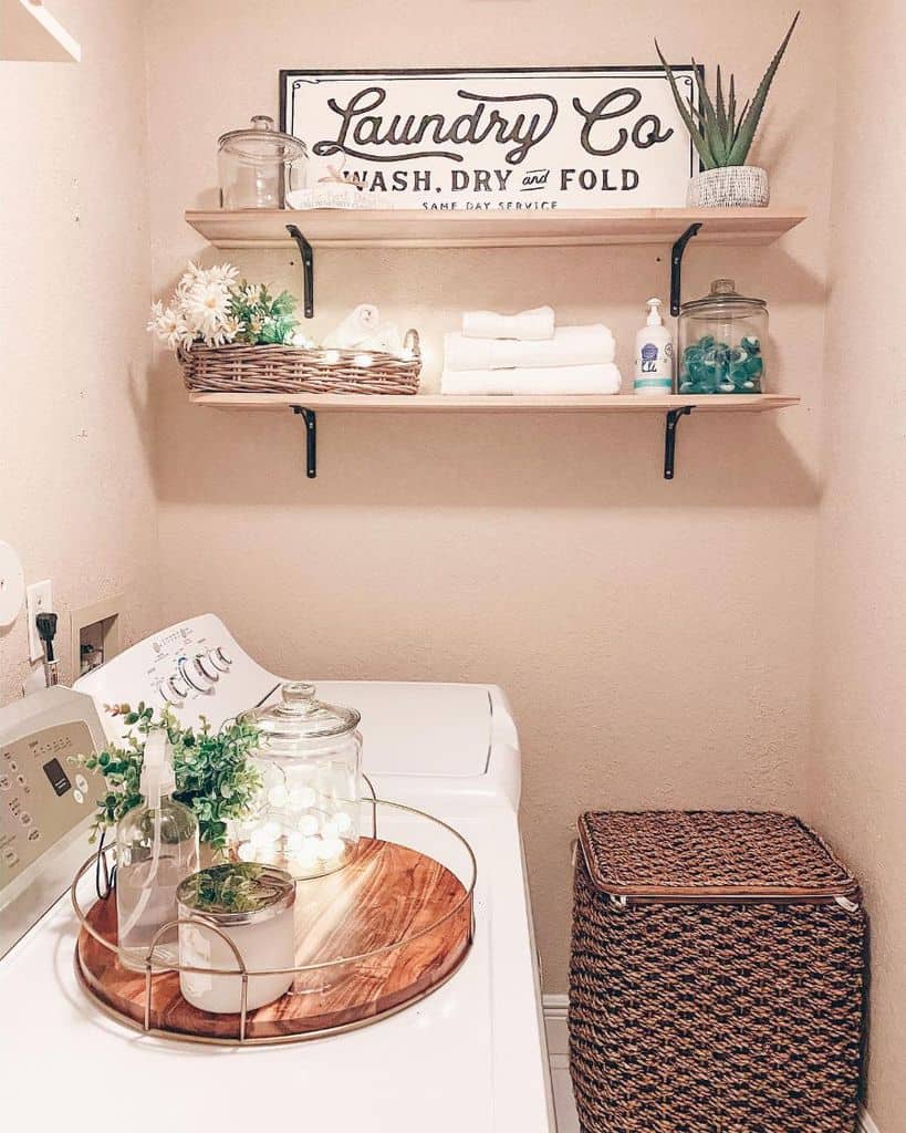 pink wall farmhouse laundry room with shelving