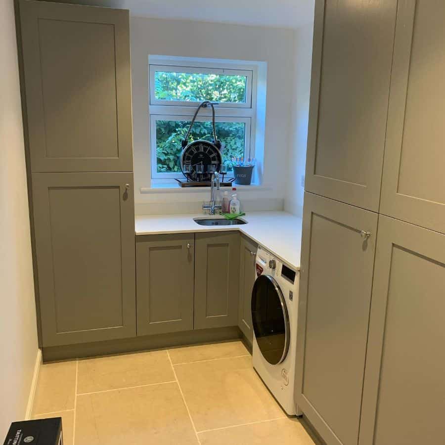 small laundry room gray cabinets sink and washer