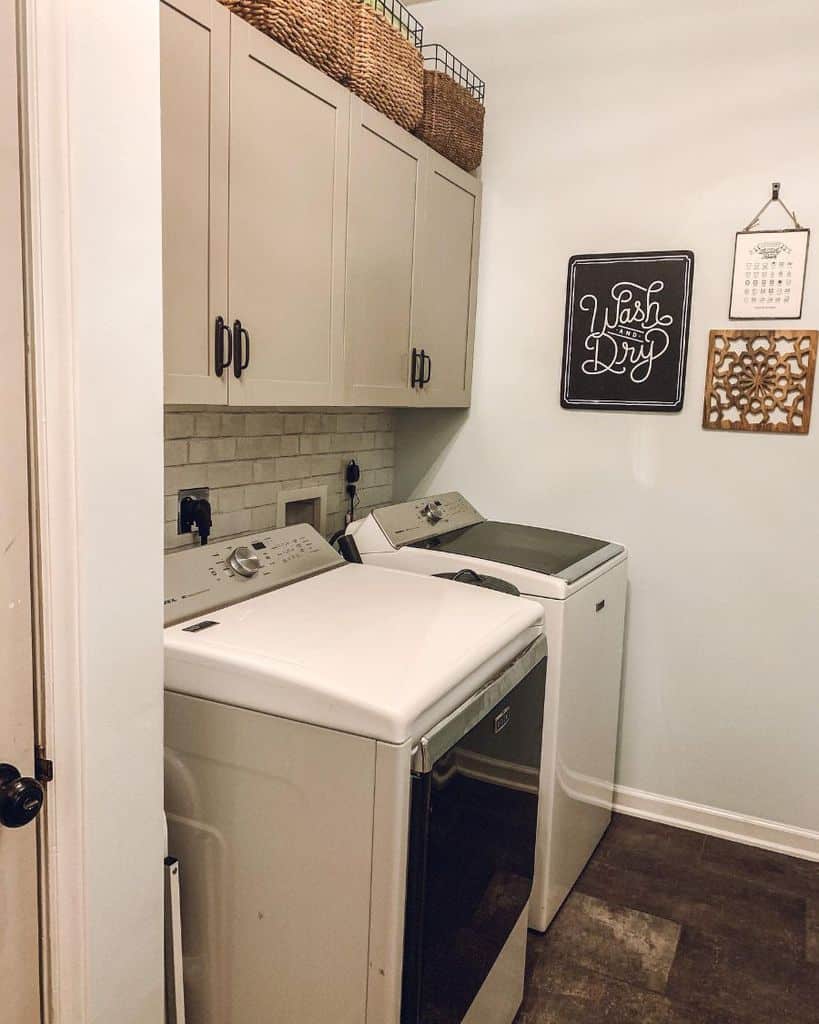 small rustic laundry with brick accent wall