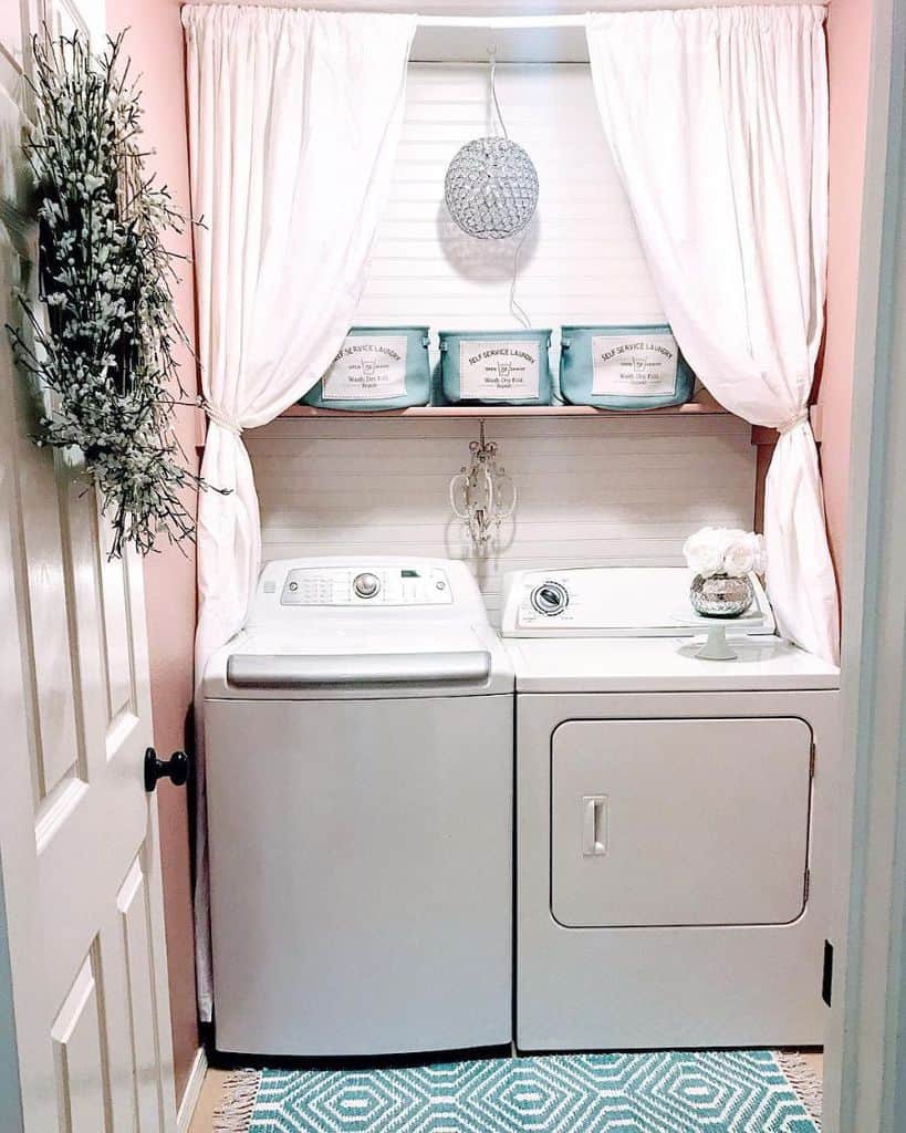 small country laundry room with pink walls and shiplap