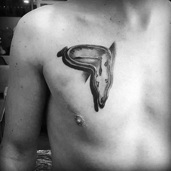 Small Melting Clock Chest Tattoo On Guy
