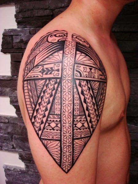 Tattoo of intricate tribal design on a man's upper arm and shoulder