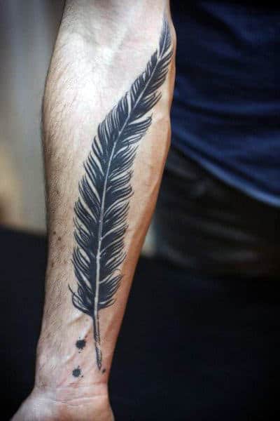 Forearm tattoo of a large, detailed feather extending from wrist to elbow