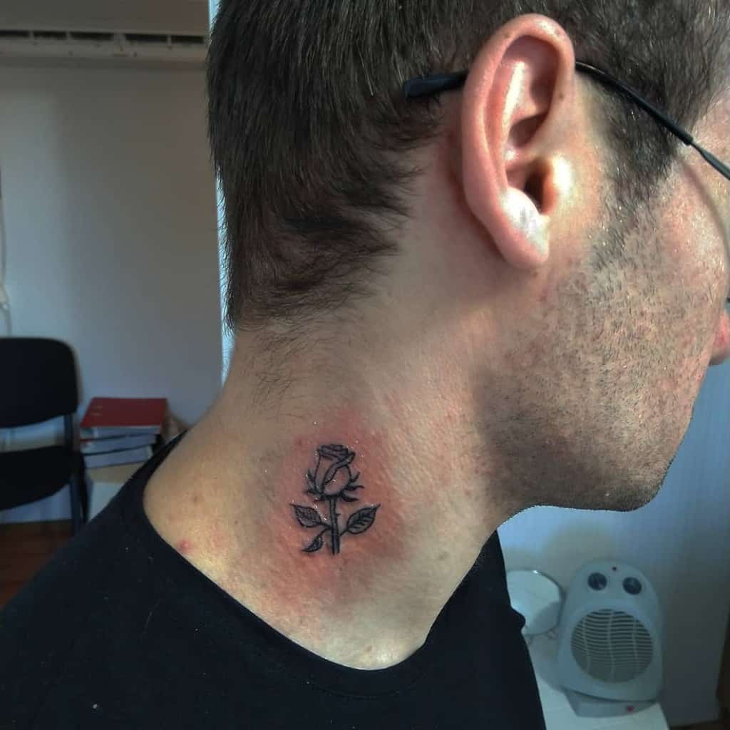 A man with a rose tattoo elegantly inked on his neck