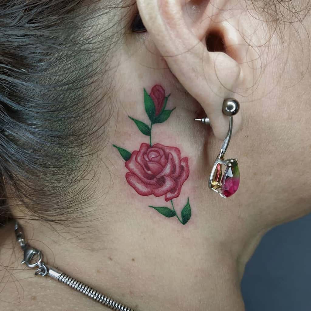 Minimalist rose neck tattoo featuring a vibrant red rose with green leaves, symbolizing elegance and beauty