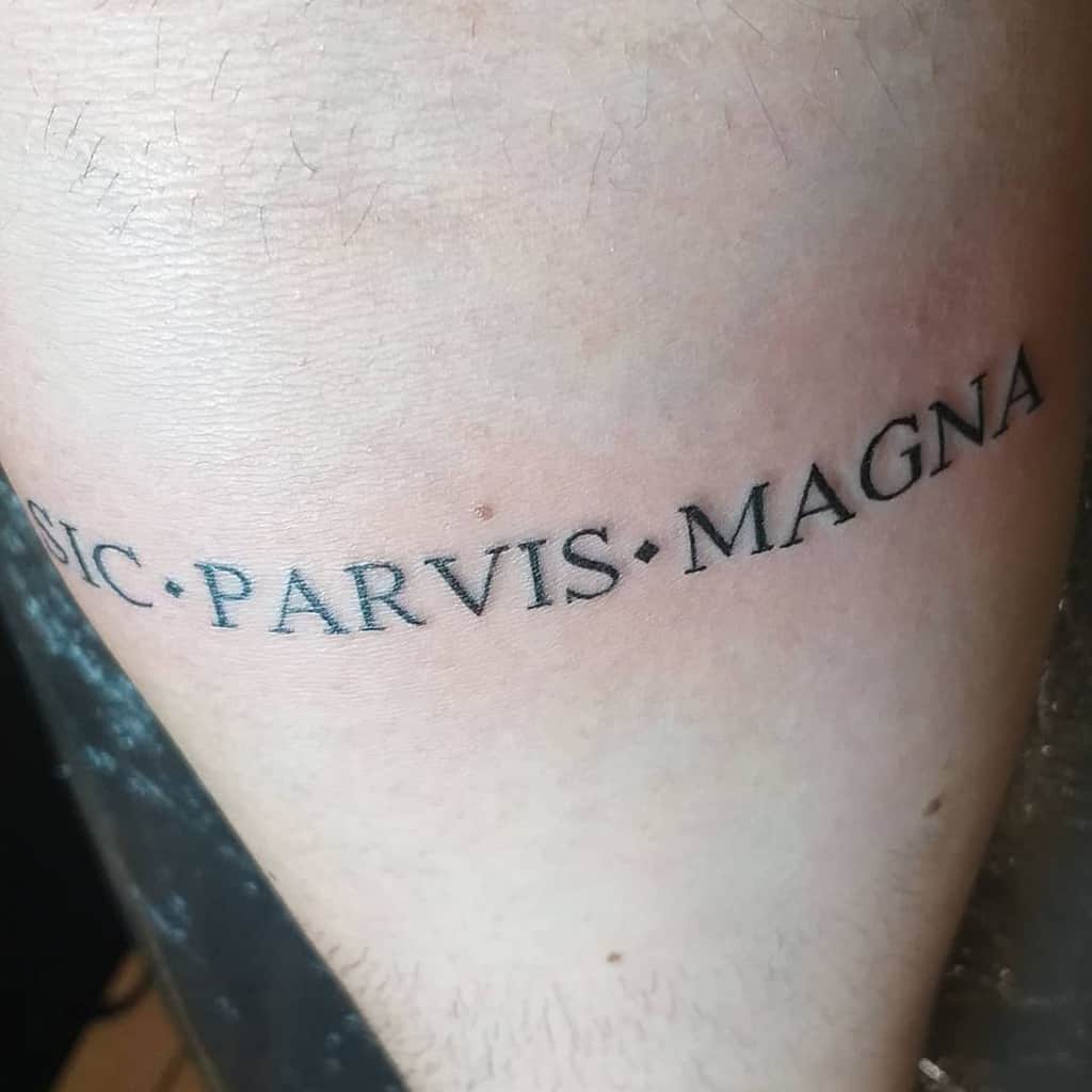 Simple tattoo with 'Sic Parvis Magna' text in bold black font, spaced with dots for a clean and minimalist design