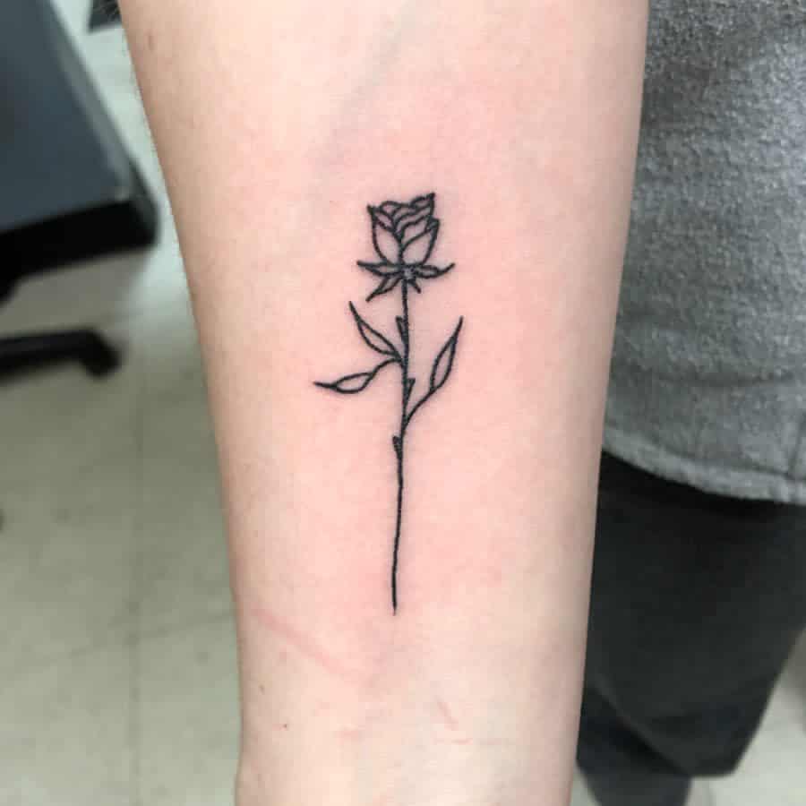 Minimalist rose tattoo on a forearm