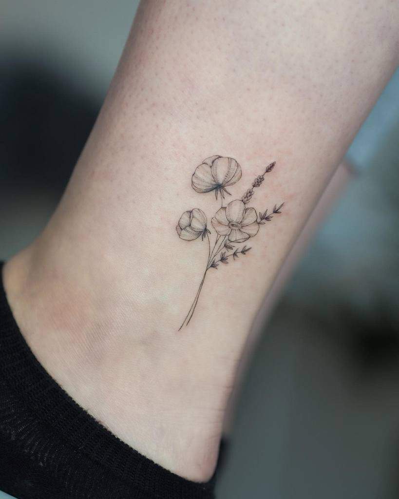 Minimalist flower tattoo on an ankle with fine line details