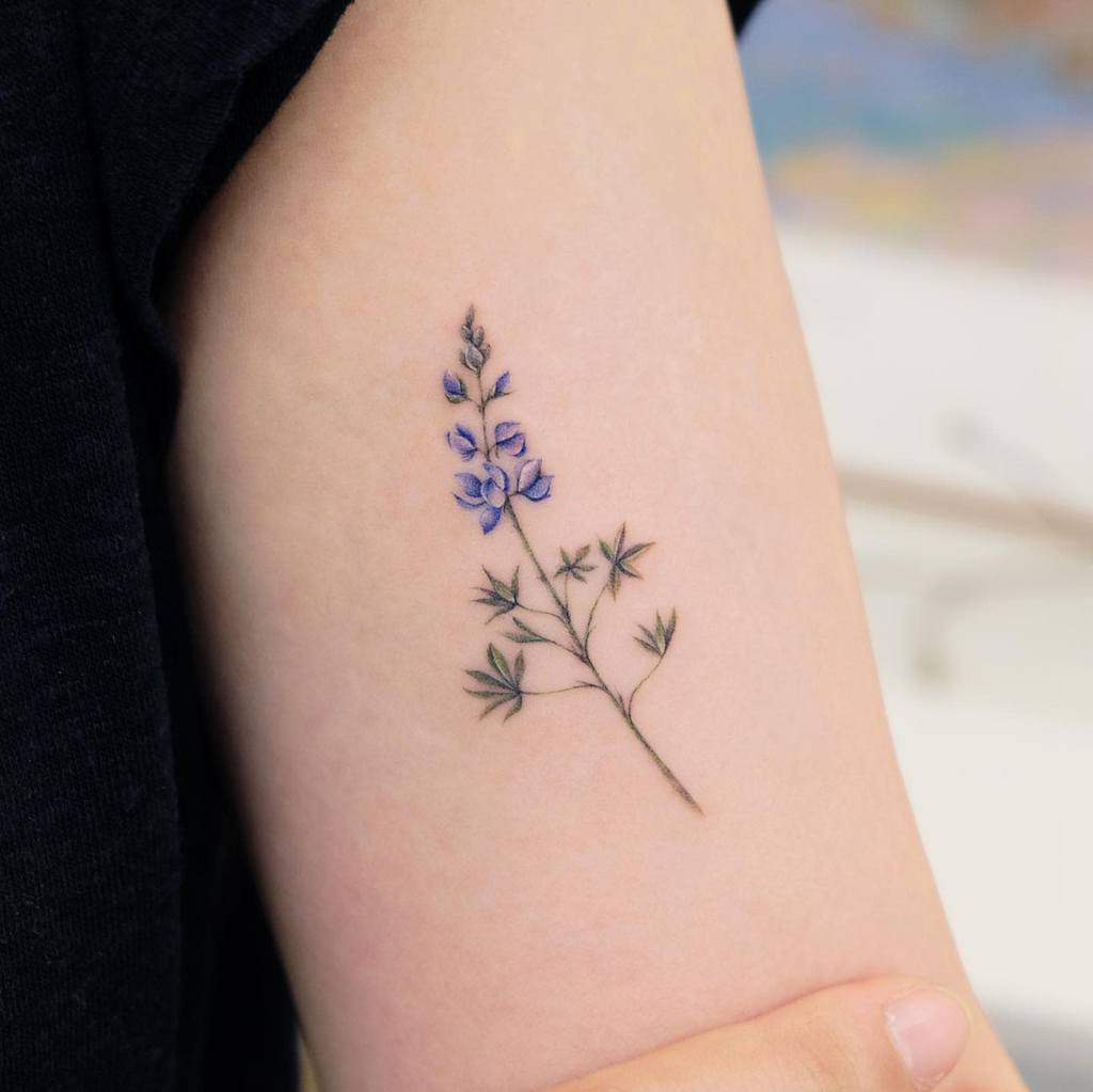 Delicate lavender flower tattoo on inner arm