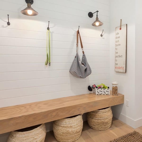 white shiplap wall with bench seating