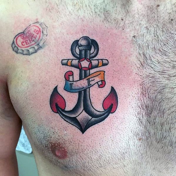 Traditional anchor tattoo on the chest with bold black outlines, red accents, and a banner, symbolizing strength, stability, and personal significance.