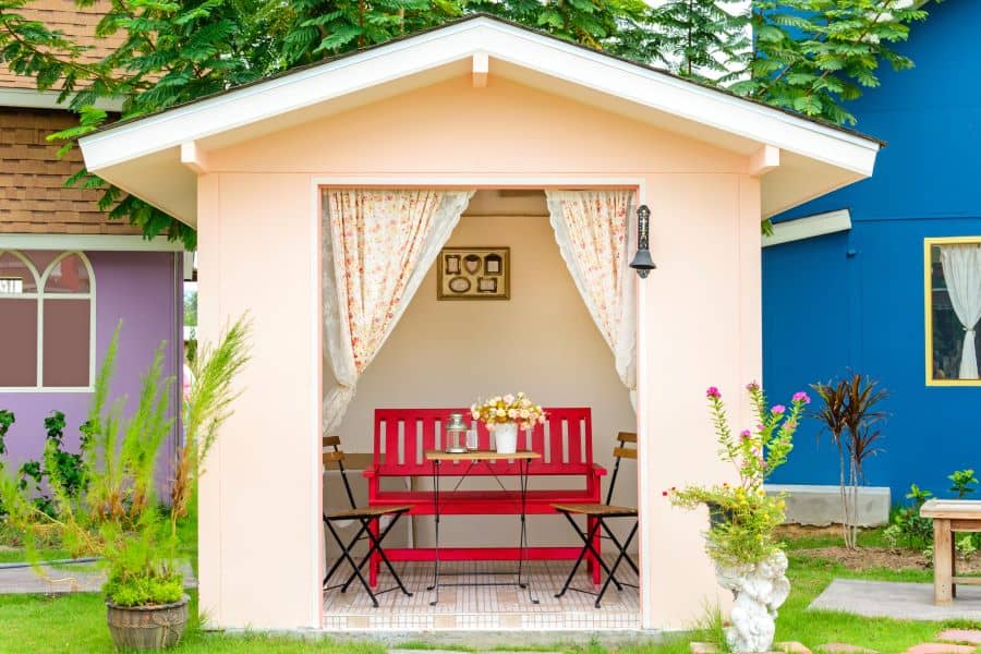 small she shed with red bench seating 