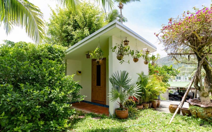 small luxury she shed with hanging pot plants 