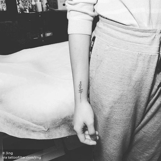 Small Unalome tattoo on the wrist, symbolizing the journey through life, personal growth, and spiritual enlightenment.