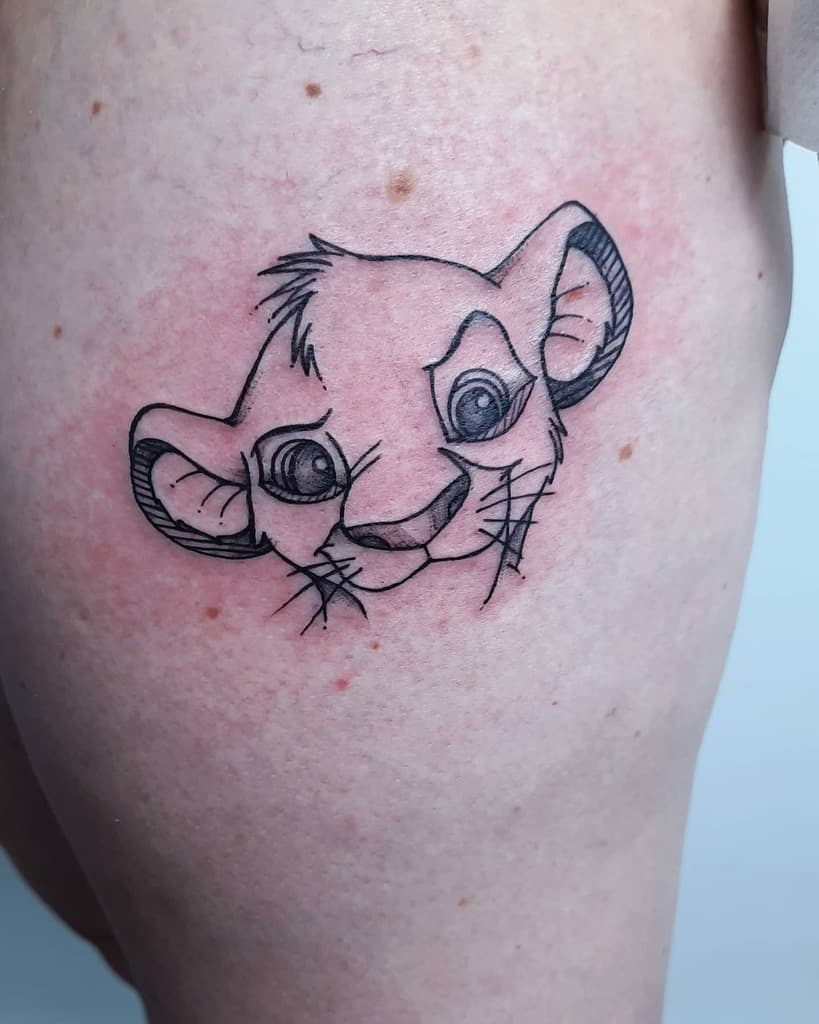 Line drawing tattoo of Simba's face with expressive eyes and gentle features, capturing his youthful charm