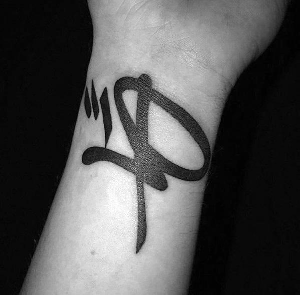 Bold black Linkin Park 'LP' logo tattoo on the wrist, featuring a minimalist yet striking design.