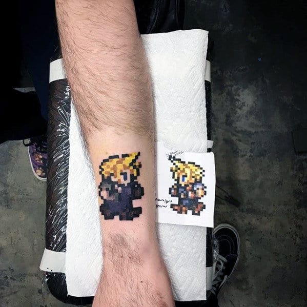 small simple final fantasy symbol wrist tattoo with black ink design