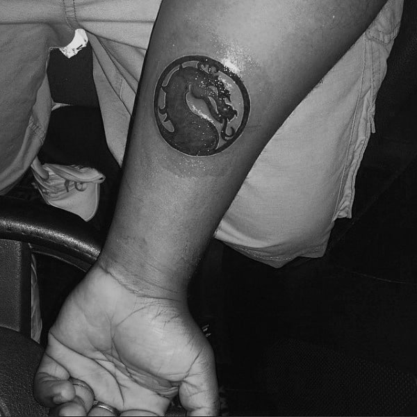 Small Simple Mens Mortal Kombat Logo Tattoo On Inner Forearm