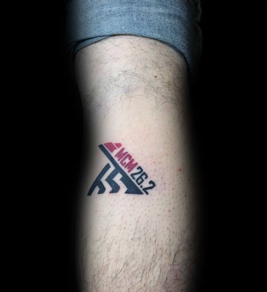 Minimalist NCM 26.2 marathon tattoo with bold lines and stylized runner, honoring the National Capital Marathon achievement.