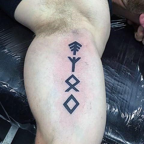 Small Simple Rune Bicep Tattoo On Guy