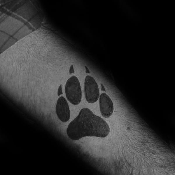 Small Simple Wolf Paw Forearm Solid Black Ink Tattoo On Guy