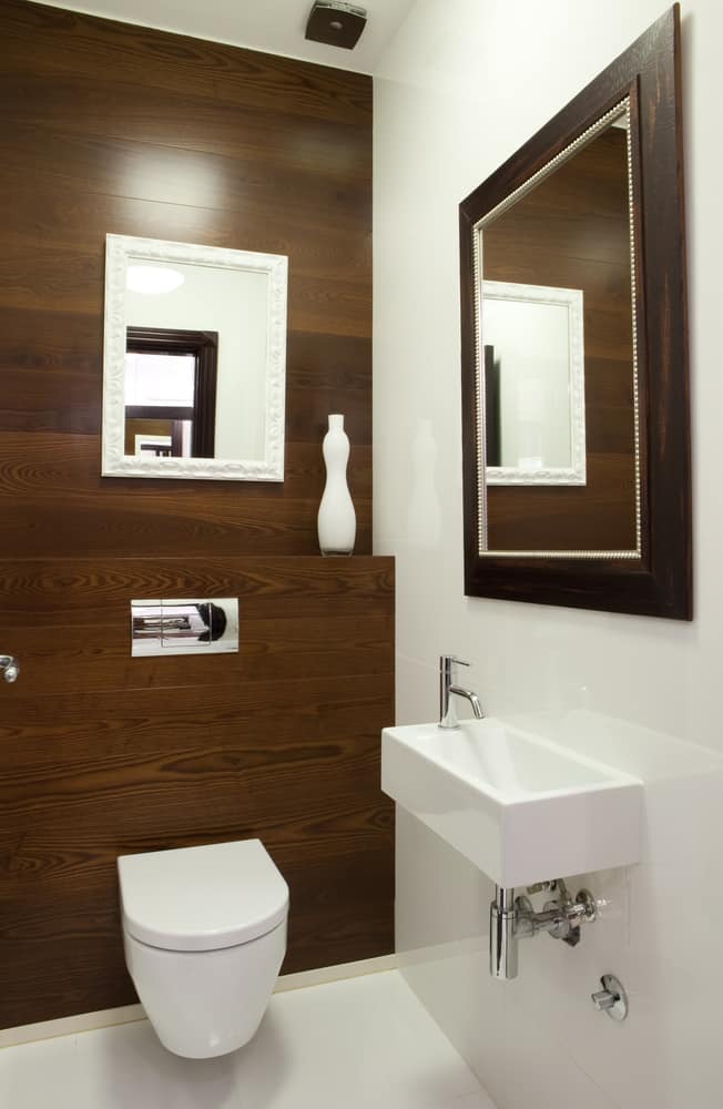 brown panel and white tile powder room