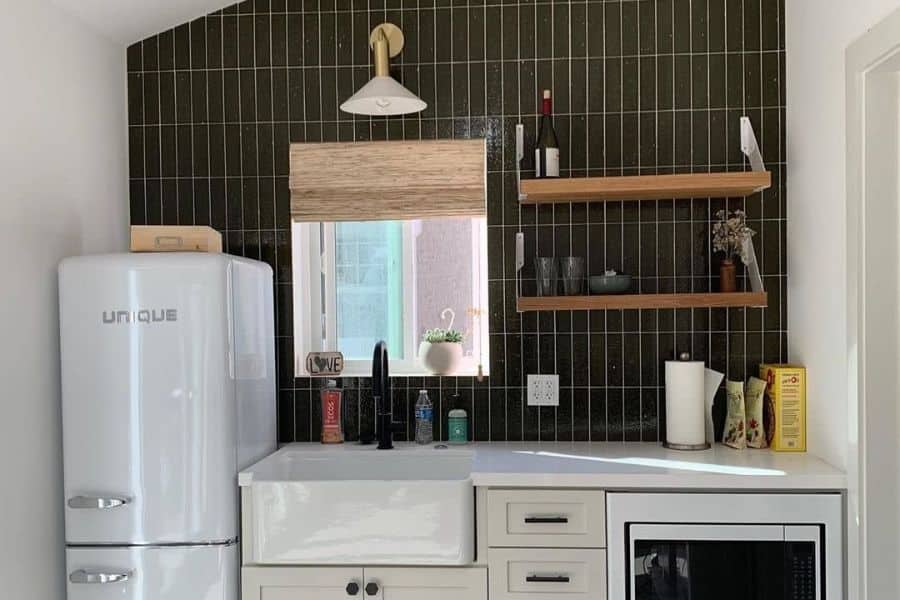 small rustic kitchen with apron sink and brown tile feature wall
