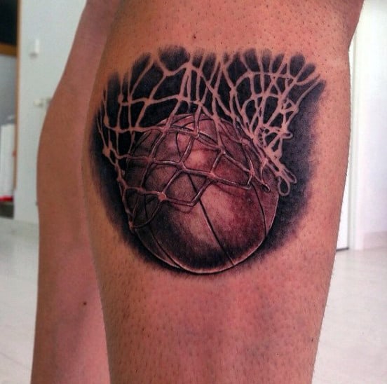 Tattoo of a basketball going through a net on the back of someone's leg