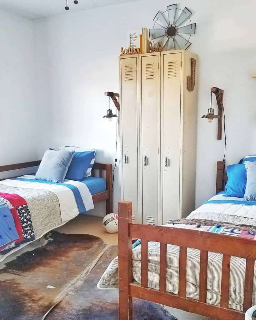 Twin boys bedroom with vintage lockers wall sconces and rustic wood beds.