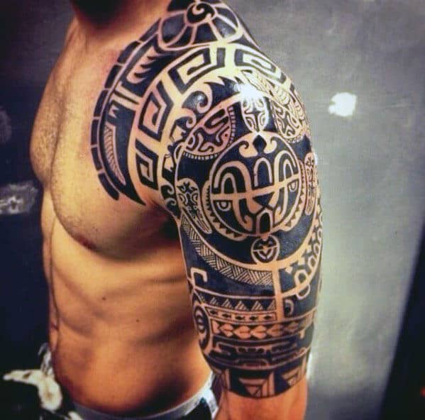 Man with intricate tribal tattoo covering his upper arm and shoulder