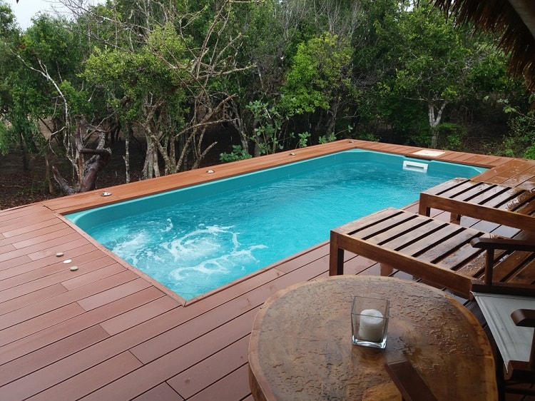 small tropical composite above ground pool deck