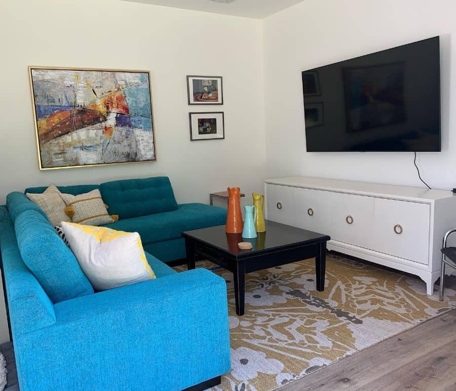 small tv room with blue sofa and white cabinet 