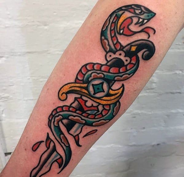 Traditional snake and dagger tattoo on forearm, featuring bold black, red, and yellow ink with intricate details and classic old-school shading.