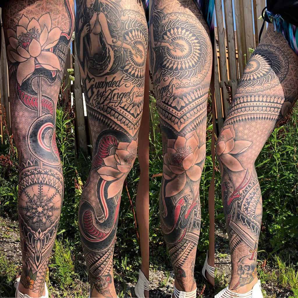 Colorful leg sleeve tattoo featuring lotus flowers, woman snakes, geometric patterns, and a skull, with the phrase 'Guarded by Angels' 