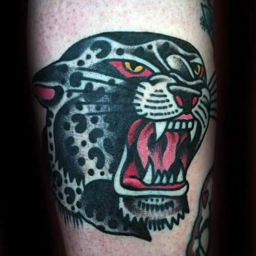 Bold traditional snow leopard tattoo with red eyes, open mouth, and sharp teeth, featuring classic thick outlines and vibrant contrast.