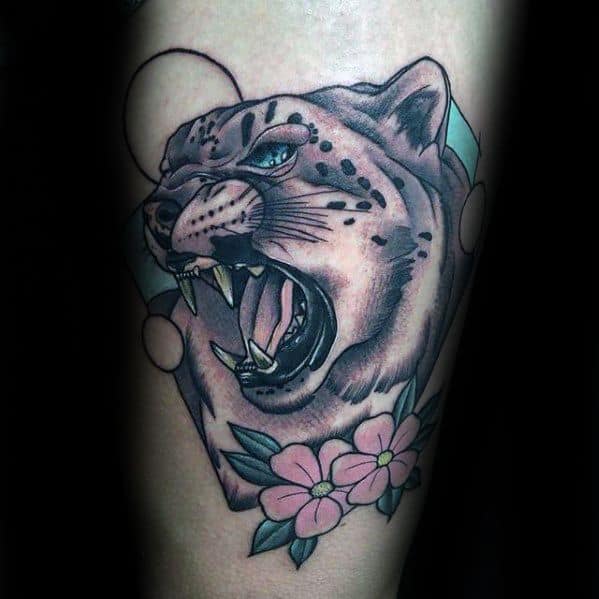 Neo-traditional snow leopard tattoo with a fierce expression, soft pink flowers, and geometric accents for a bold yet elegant design.