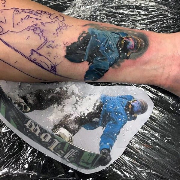 Realistic color tattoo of a snowboarder in motion, based on a photo reference, capturing snow spray and winter gear in vivid detail.