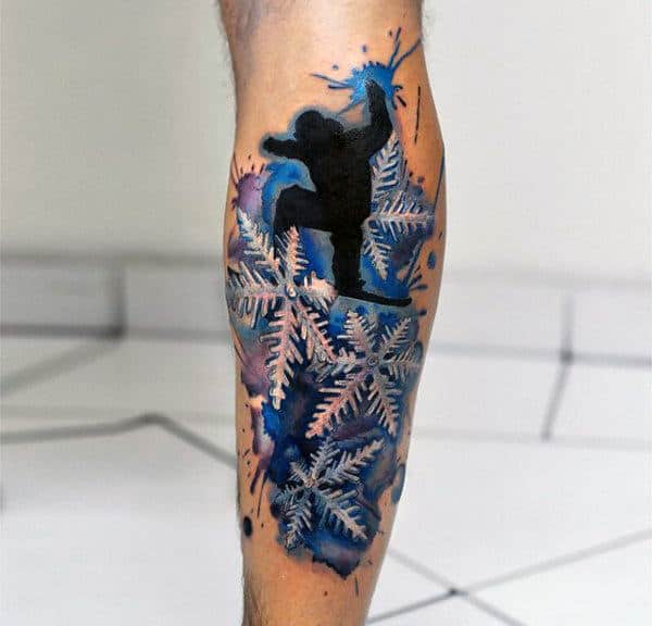 Snowboarding Snowflake Guys Back Of Leg Tattoo With Watercolor Blue Background Design