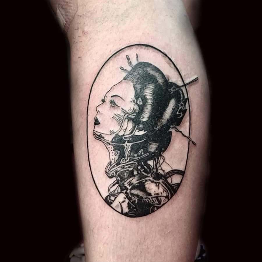 Black ink cyberpunk Geisha tattoo featuring mechanical details, intricate circuitry, and a traditional hairstyle, enclosed within an oval frame.